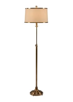 a floor lamp with a white shade on it's base and a gold finish