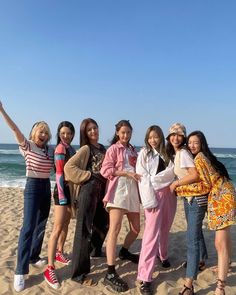 the girls are posing on the beach together