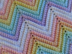 crocheted squares are arranged in different colors