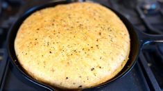 a skillet that is sitting on top of a stove with some food in it