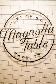 the sign on the wall says, meet me at magnotia table