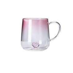 a pink and white coffee mug with a heart on the inside, sitting in front of a white background