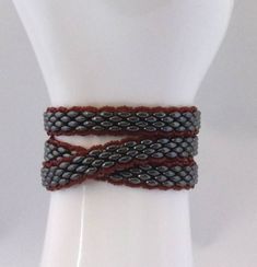 "A triple wrap bracelet, made from SuperDuo brand beads in \"black luster\", embellished along the edges with tiny dark red seed beads. This bracelet will comfortably wrap 3 times around a wrist that is 6 1/4\" or less around. My own wrist is 6 1/2\" and this bracelet is a little snug on me, as you might be able to tell from the photos. So, please, be sure of your wrist measurement before ordering. Thanks." Wire Knitting, Triple Wrap Bracelet, Four Leaf Clover Necklace, Large Necklace, Beaded Wrap Bracelets, Wire Wrapped Necklace, Fun Earrings, Wire Wrapped Pendant, Clover Leaf