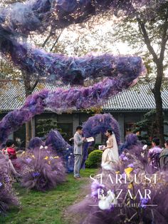 a bride and groom standing in front of purple flowers with the caption tarbust bay air