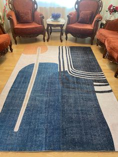 a living room filled with furniture and a blue rug