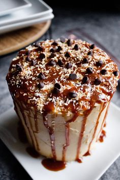 a cupcake with chocolate chips and caramel drizzled on the top