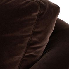 a close up view of the back end of a brown couch with pillows on it