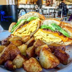 a sandwich and some fried potatoes on a plate