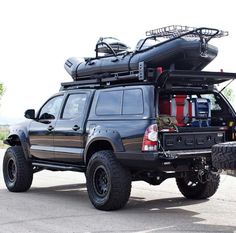 a truck with an open top and luggage strapped to the back