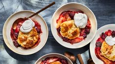 three bowls filled with fruit and topped with whipped cream