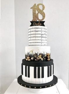 a black and white cake with gold numbers on top