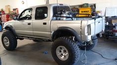 a silver truck parked inside of a garage