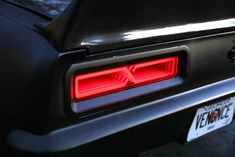 the tail lights of a black sports car