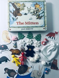 the mitten by jan breit is surrounded by cut outs and magnets to decorate it