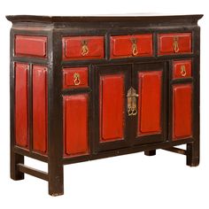 a red and black cabinet with gold hardware on the doors, sideboard or buffet