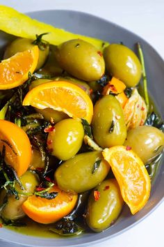 a bowl filled with olives and orange slices