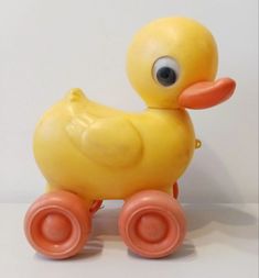 a yellow rubber ducky toy sitting on top of a white surface