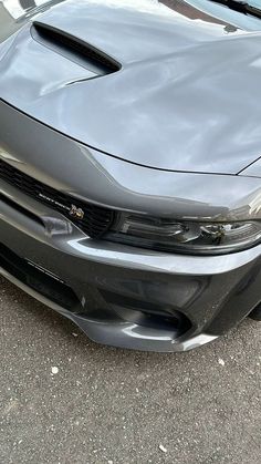 the front end of a gray sports car