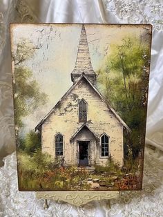 an old white church with a steeple painted on it