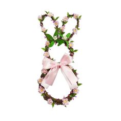 a pink bow tied to a twig with flowers and leaves on it's side