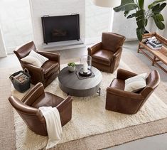 a living room with brown leather chairs and a white rug on the floor in front of a fireplace