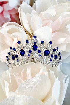 a blue tiara sitting on top of a white flower