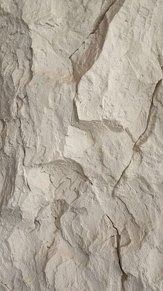 a close up view of a white rock textured with cement or concrete mortars