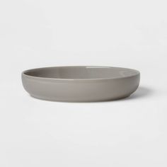 a gray bowl sitting on top of a white table