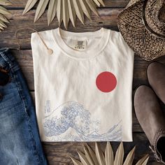 Japanese Wave T-Shirt, The Great Wave Shirt, Japanese Art Shirt, Aesthetic  Shirt, Japanese Tee, Wave Shirt, Art Shirt, Oversized Shirt 🌸Item Details:🌸 -Made to order -Unisex Tee  -Available in many sizes and colors!  -Super Versatile -For an oversized look I recommend sizing up -Japanese Wave Art Tee ⭐️Materials: ⭐️ COMFORT COLORS  ⭐️100% ring-spun cotton ⭐️Medium fabric (6.1 oz/yd² (206.8 g/m ⭐️Relaxed fit ⭐️Sewn-in twill label **Please review size chart in photos prior to purchasing ✨PRODUCTION TIME✨ Production takes about 1-3 days. Within this timeframe you will receive an email letting you know your item has shipped with a tracking number for your item. ✨SHIPPING TIME✨ Shipping takes about 2-5 days. ✨CARE INSTRUCTIONS ✨ COMFORT COLORS -Wash separately to avoid color bleeding or wash Artistic Crew Neck Shirt With Custom Print, Artsy White Crew Neck T-shirt, Artistic White Shirt With Screen Print, Artistic White Relaxed Fit Shirt, Artistic Graphic Crew Neck Shirt, Artsy Cotton Shirt With Graphic Design, Artsy Cotton T-shirt With Crew Neck, Artistic Cotton Tops With Front Print, Artistic Relaxed Fit Shirt With Screen Print