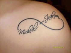 the back of a woman's shoulder with a tattoo that reads, michael jackson