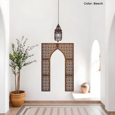 a white room with an archway, potted plant and decorative wall hanging on the wall