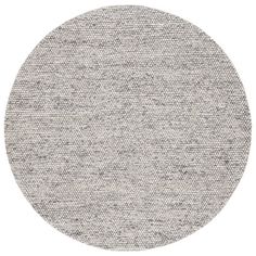 a round rug with grey and white dots