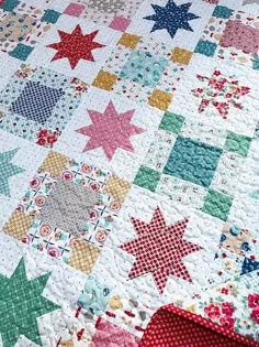 a close up of a quilt with stars on it