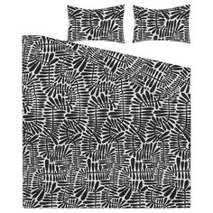 black and white bedding with an abstract pattern on the pillowcase, along with two pillows