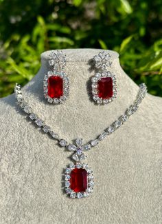 Handmade Style: Necklace and Earrings Set Material: Platinum Plated, Lab Simulated Ruby and White Sapphire Stones Imported Please Note: This necklace and earrings are sold as a set. Item Number: 7078R Luxury Elegant Ruby Beaded Necklaces, Luxury Vintage Ruby Necklace, Luxury Red Dangle Jewelry, Fine Ruby Drop Earrings Jewelry, Elegant Ruby Jewelry Sets With Matching Earrings, Fine Ruby Drop Earrings, Formal Pendant Jewelry With Stones, Crystal Necklace And Earring Set For Gifts, Wedding Drop Earrings With Stones