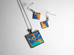 This set, consisting of a necklace and earrings, is inspired by the famous painting by  Henri Matisse "Dance". The set is entirely made and hand painted with oil colors on small wooden bases. The earrings, with a silver setting, represent a diamond-shaped detail of the painting, the miniature measures 1.2 cm while the total length is approximately 3cm. The necklace represents a detail of the painting, and is framed by a square silver frame; the miniature measures 2.5 cm while the total length of Henri Matisse Dance, Matisse Dance, Diamond Shaped, Henri Matisse, Necklace And Earrings, Silver Frame, Diamond Shapes, Lovers Art, Jewelry Sets