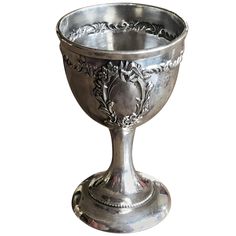 an ornate silver goblet on a white background