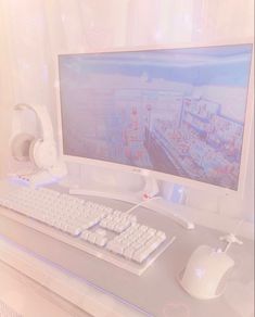 a computer monitor sitting on top of a desk next to a white keyboard and mouse