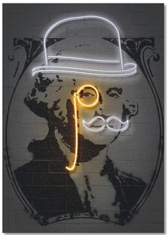 a neon sign with a man's face wearing a hat and moustache