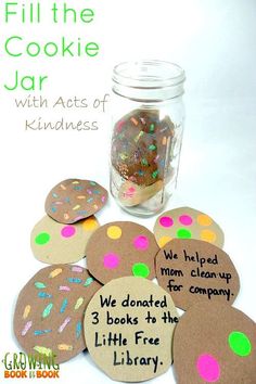 a jar filled with lots of cookies next to a pile of paper circles that read, fill the cookie jar with acts of kindness