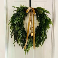 a wreath with bells hanging on a door