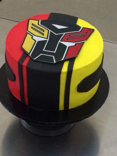 a cake that is decorated to look like a robot suit on top of a table