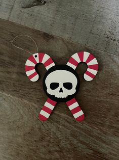 a wooden decoration with a skull and candy canes