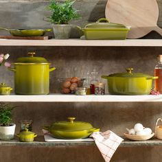 green pots and pans on shelves in a kitchen