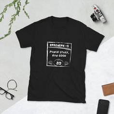 a black t - shirt with the words ok millennium printed on it next to an old camera