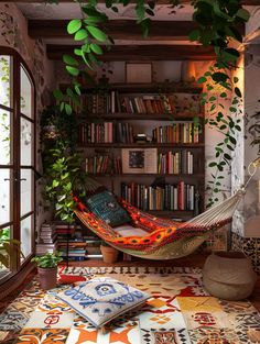 a hammock hanging in front of a book shelf filled with books