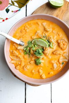 a white bowl filled with tortilla soup and garnished with cilantro