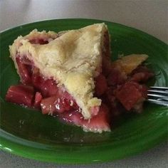 a piece of pie sitting on top of a green plate