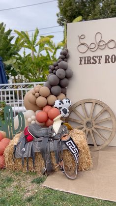 there is a horse and carriage made out of hay next to a sign that says first rodeo