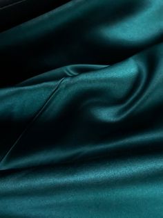 a close up view of a dark green fabric